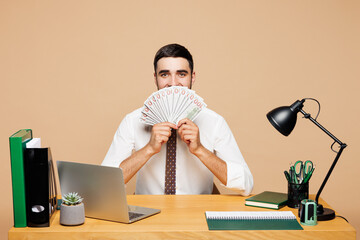 Young employee business man in white shirt sit work at office desk with pc laptop hold cover mouth...