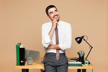Young minded successful employee business man wear white shirt tie work at office stand near desk...