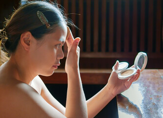 Beauty & Skincare, Beautiful woman sitting applying translucent face powder when doing make-up,...