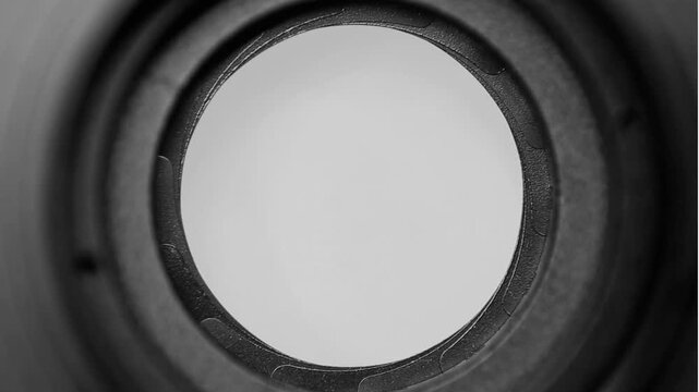 Close-Up View Through Circular Aperture in Grayscale Photography