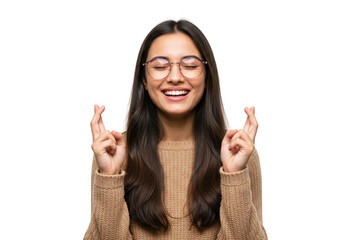A happy young woman with glasses crosses her fingers for luck, isolated on a transparent background