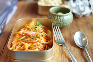 Tomato Spaghetti in a Lunch Box on Wooden Table