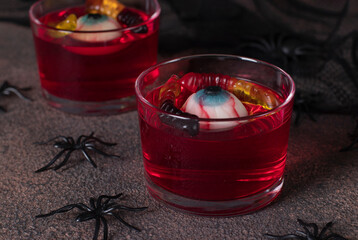 Jelly fruit dessert with candies in shape of eyes and worms
