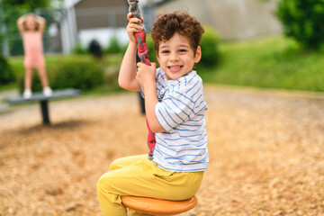 Happy 5 years old girl on a playground © Louis-Paul Photo