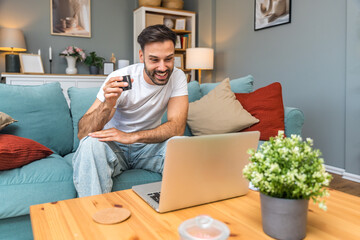 Young business man small startup company owner, working at home, checking the finances on graphs...