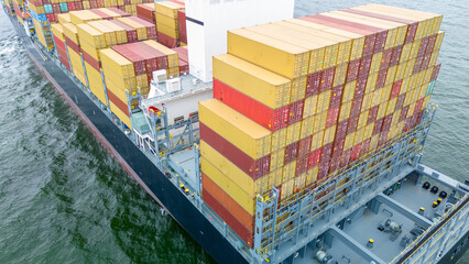 Stern of cargo ship carrying container and running for export goods from cargo yard port to custom...