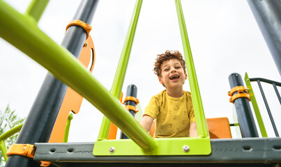 Happy kid on playground on summer season