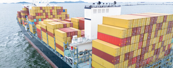 Stern of cargo ship carrying container and running for export goods from cargo yard port to custom...