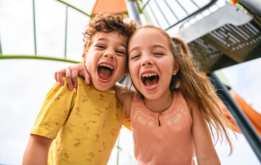 Happy kids on playground in summer season