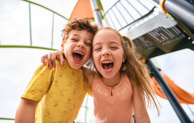 Happy kids on playground in summer season