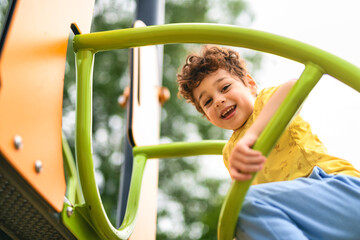 Happy kid on playground on summer season