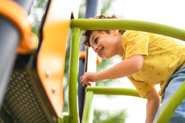 Happy kid on playground on summer season