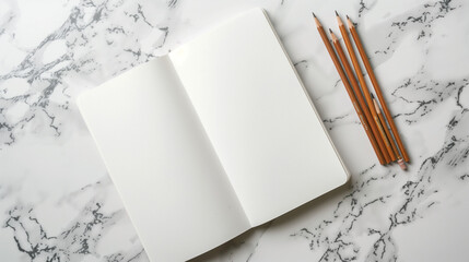 White Sketchbook with Brown Pencils on Marble Desk 