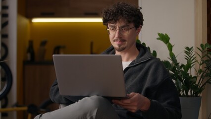Joyful smiling Caucasian hipster male adult guy worker businessman communicating laptop man...