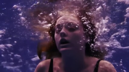 Dramatic underwater view of a young woman sinking and struggling surrounded by rising bubbles - Powered by Adobe