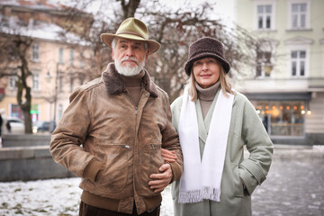 Lovely senior couple walking on city street