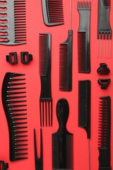 Different hairdresser's tools on red background, flat lay