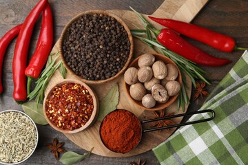 Different aromatic spices on wooden table, flat lay