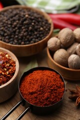 Different aromatic spices on wooden table, closeup
