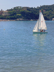 Sestri Levante, Italy - July 15, 2025. Sailboats in sea. Sport and sailing school for teenagers and adults. Nature and vacation in Italy. Leisure and seasons.