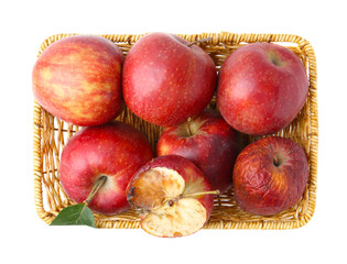 Spoiled apple and good ones in basket isolated on white, top view