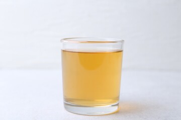 Glass with dirty water on light table, closeup