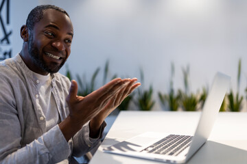 African American businessman participating in video call, discussing project performance in office
