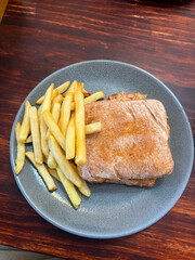 A plate of burger and chips.