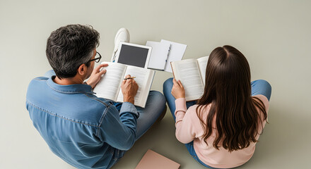 Couple Studying Together with Books and Tablet on Floor
