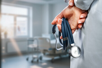 Close-up of doctor in white medical coat with stethoscope, cropped professional figure representing medicine, health care, regular check-ups, prevention and medical diagnostics concept.