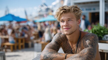 Charming young man enjoying a sunny day by the beachside café
