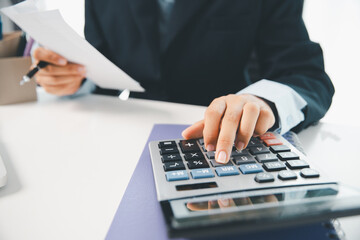 Woman calculating monthly home expenses, taxes, bank account balance and credit card bills payment,...