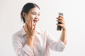Asian woman rejoicing, looking happy, champion, fist pump gesture, standing over white background....
