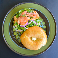 A salmon bagel with rocket and Spanish onion. 