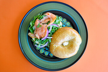 A salmon bagel with rocket and Spanish onion. 