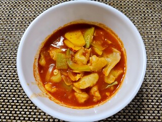 Traditional Korean spicy sujebi soup with hand-torn dough, zucchini, and potato in a rich red chili...