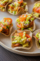 close up stock photo of guacamole bites served as a fresh party appetizer. perfect for summer events, healthy snacking, or finger food ideas. ideal for food bloggers, catering menus, and recipe conten
