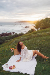 Woman Enjoying Beachside Picnic at Sunset in Tropical Sri Lanka