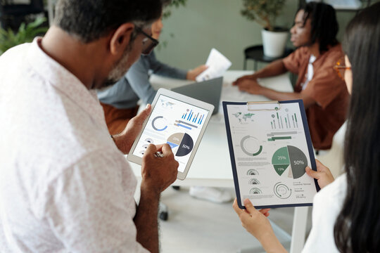 Business team discussing financial charts in an office setting