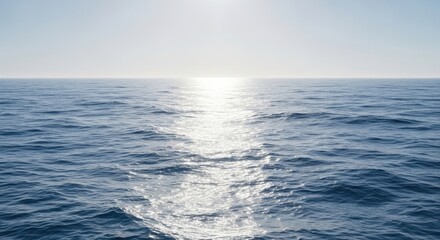 Obraz premium Sunlight glints on the calm surface of the vast blue ocean