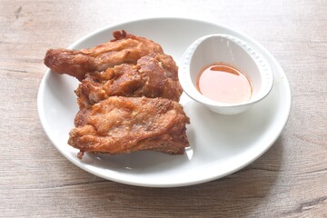 crispy chop fried chicken tight and leg on plate dipping sweet chili sauce in cup