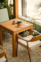 Fresh Croissant and Coffee on a Cozy Café Table

