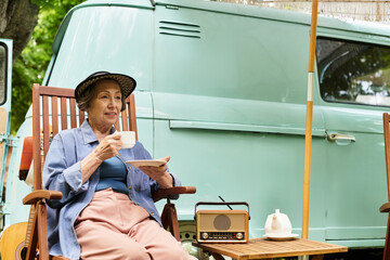 Delightful afternoon in the garden with a senior woman enjoying her tea under the sun