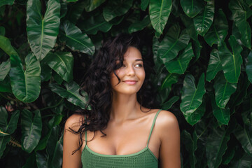 Beautiful Young Woman Posing Against Lush Green Tropical Leaves Outdoors