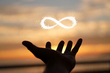 Silhouette Hand Reaching for Infinity Symbol During Sunset Creates Mysterious Ethereal Mood