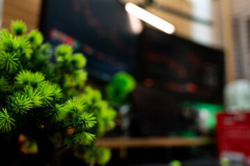 Close-up candlestick stock chart on monitor in modern studio setup with triple displays, perfect for visuals about trading, cryptocurrency, or financial analysis environments.
