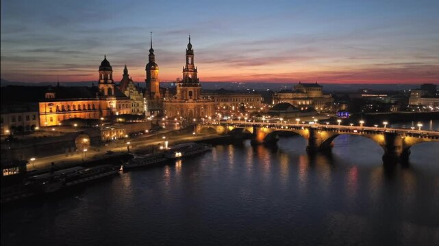 Dresden historic Old Town at night, with Elbe River reflecting city lights. Dresren, Saxony, Germany. Aerial View.