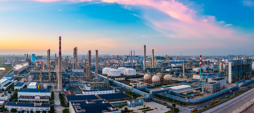 Aerial shot of oil refinery and chemical plant in large industrial area at sunset
