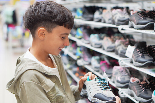 sales, back to school... preteen boy shopping, choosing sneakers