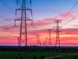High voltage power tower and beautiful sky clouds at dusk